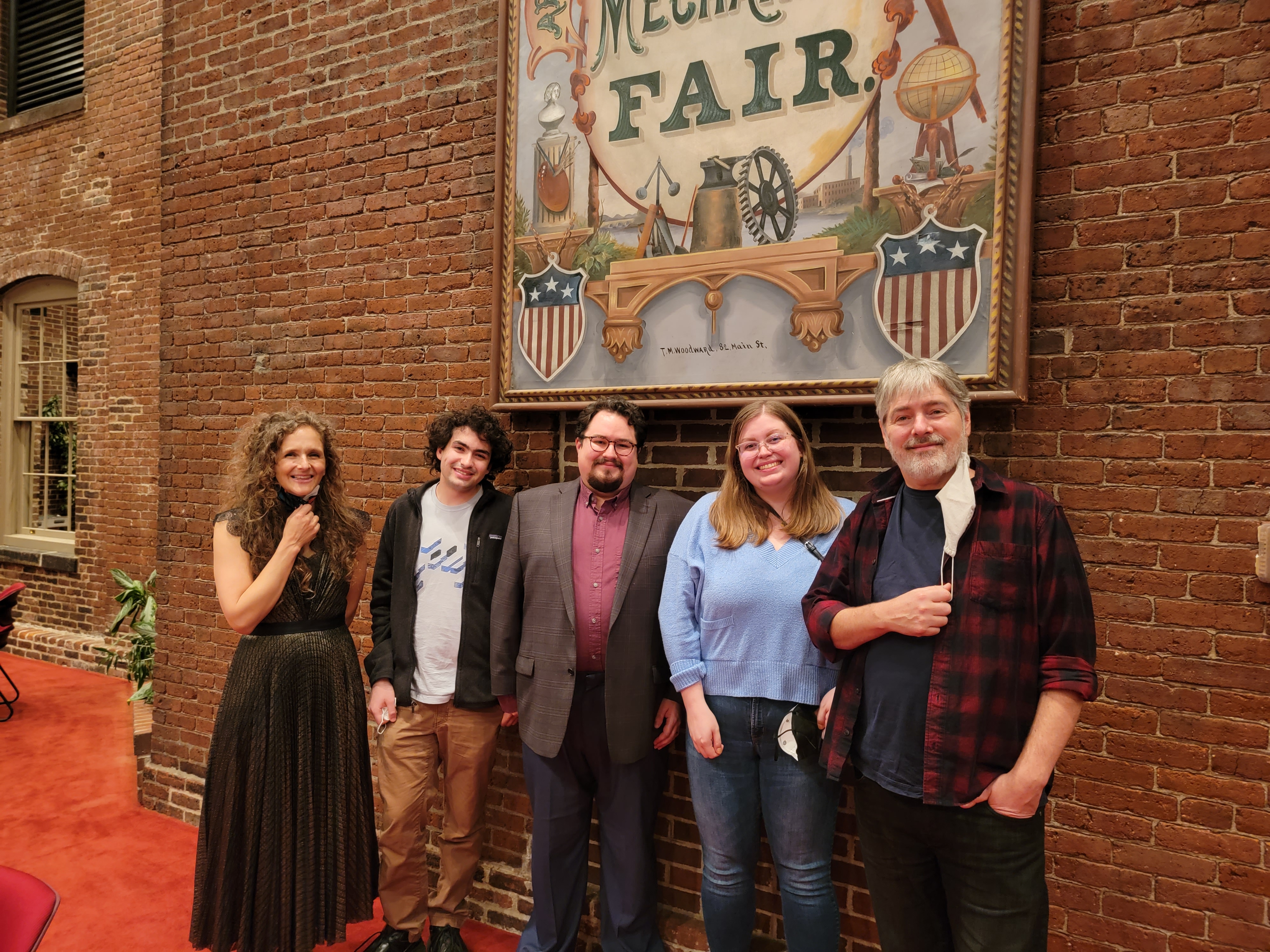 group of people beneath a sign