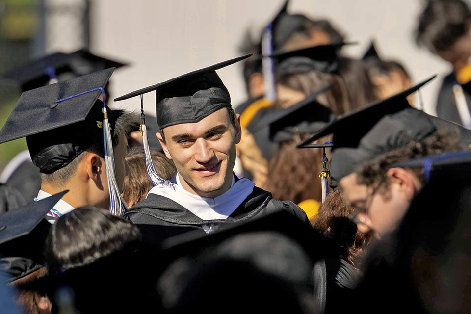 Graduates outside during Commencement